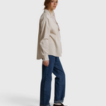 JONES + CO James button-up shirt in whitecap gray worn by a woman with blue jeans against a neutral backdrop