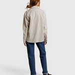 JONES + CO James button-up shirt in whitecap gray worn with blue jeans, back view