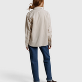 JONES + CO James button-up shirt in whitecap gray worn with blue jeans, back view