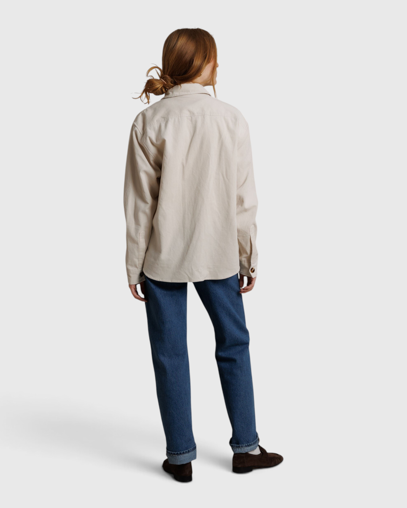 JONES + CO James button-up shirt in whitecap gray worn with blue jeans, back view
