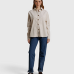 JONES + CO James button-up shirt in whitecap gray, worn with blue jeans and brown loafers against a neutral backdrop.
