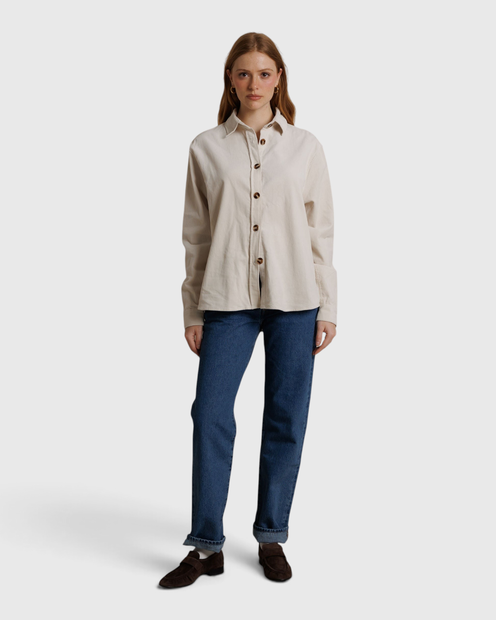 JONES + CO James button-up shirt in whitecap gray, worn with blue jeans and brown loafers against a neutral backdrop.