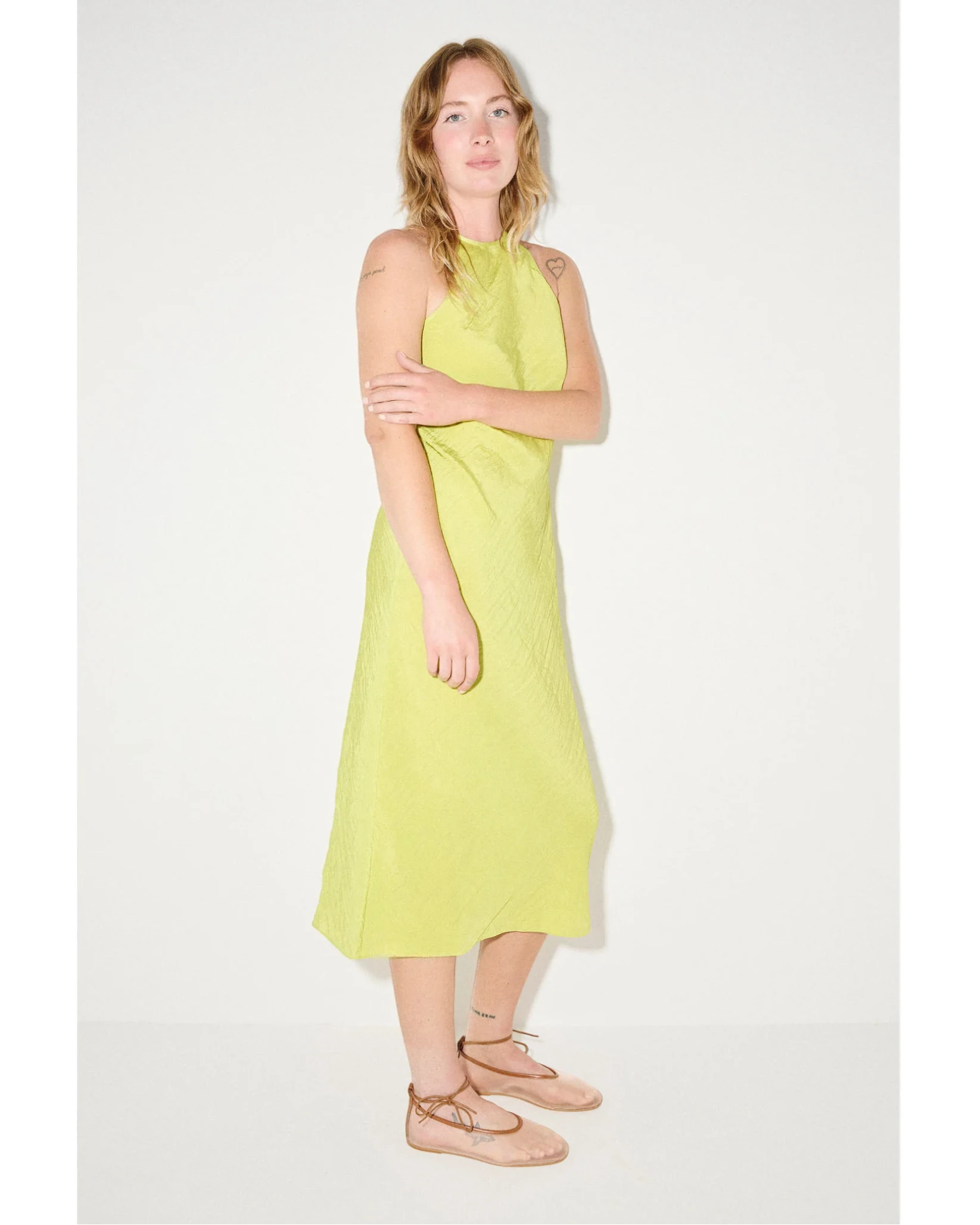 Woman wearing a light green dress on a white background