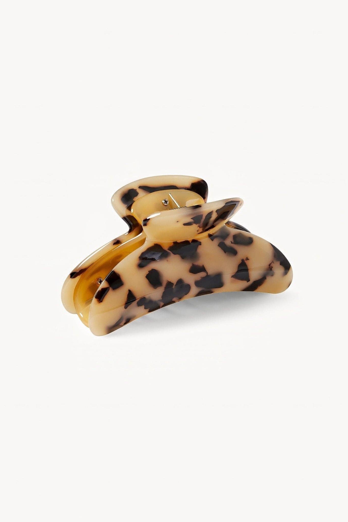 Tortoiseshell patterned hair clip on a white background