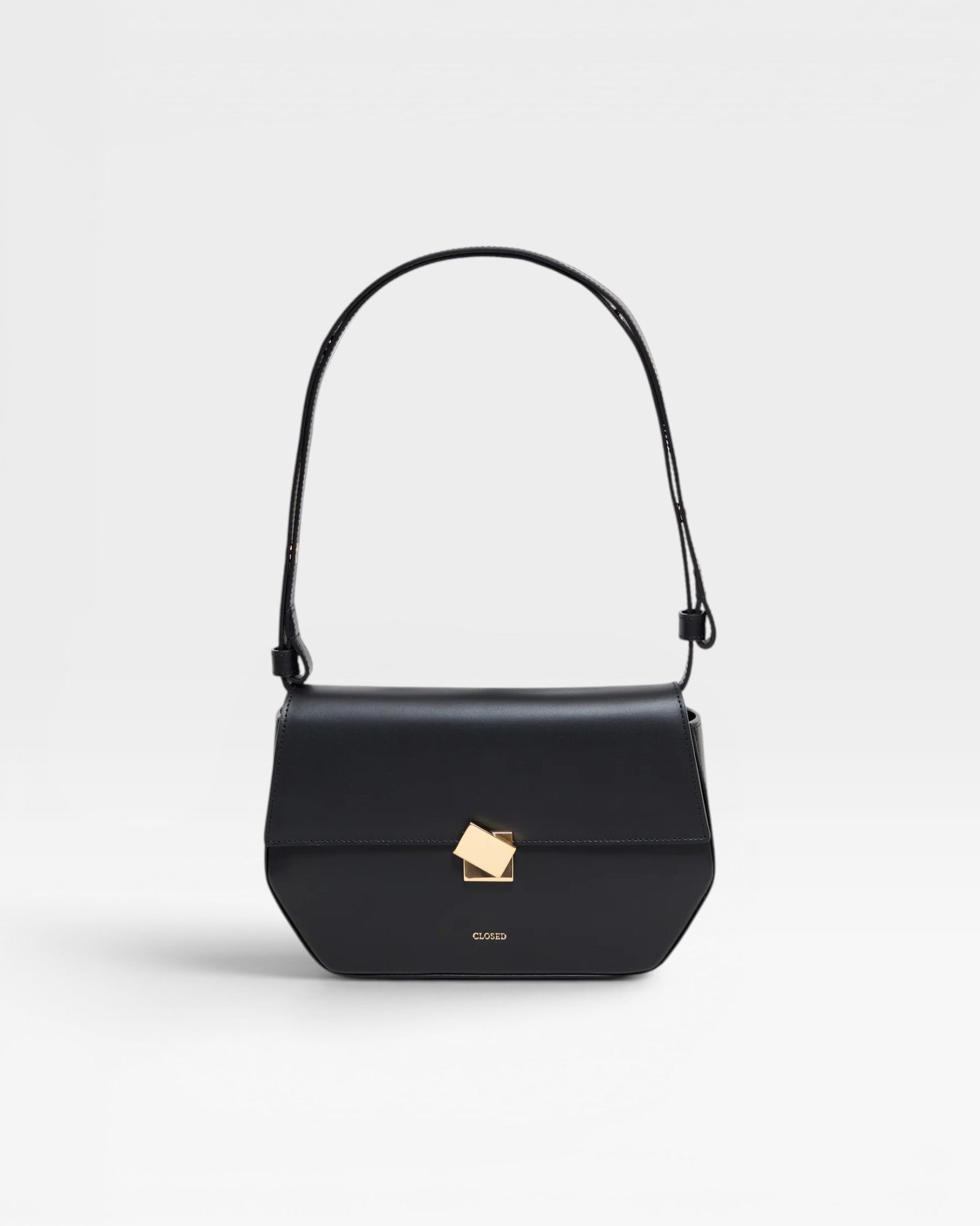 A black leather shoulder bag with a metal buckle, an adjustable strap, and the CLOSED logo embossed on the front.