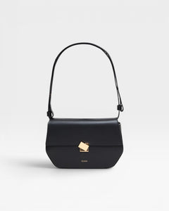 A black leather shoulder bag with a metal buckle, an adjustable strap, and the CLOSED logo embossed on the front.