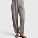 JONES + CO Dre sweatpants in cloud gray with an elastic waistband, worn with black flip-flops on a neutral background.