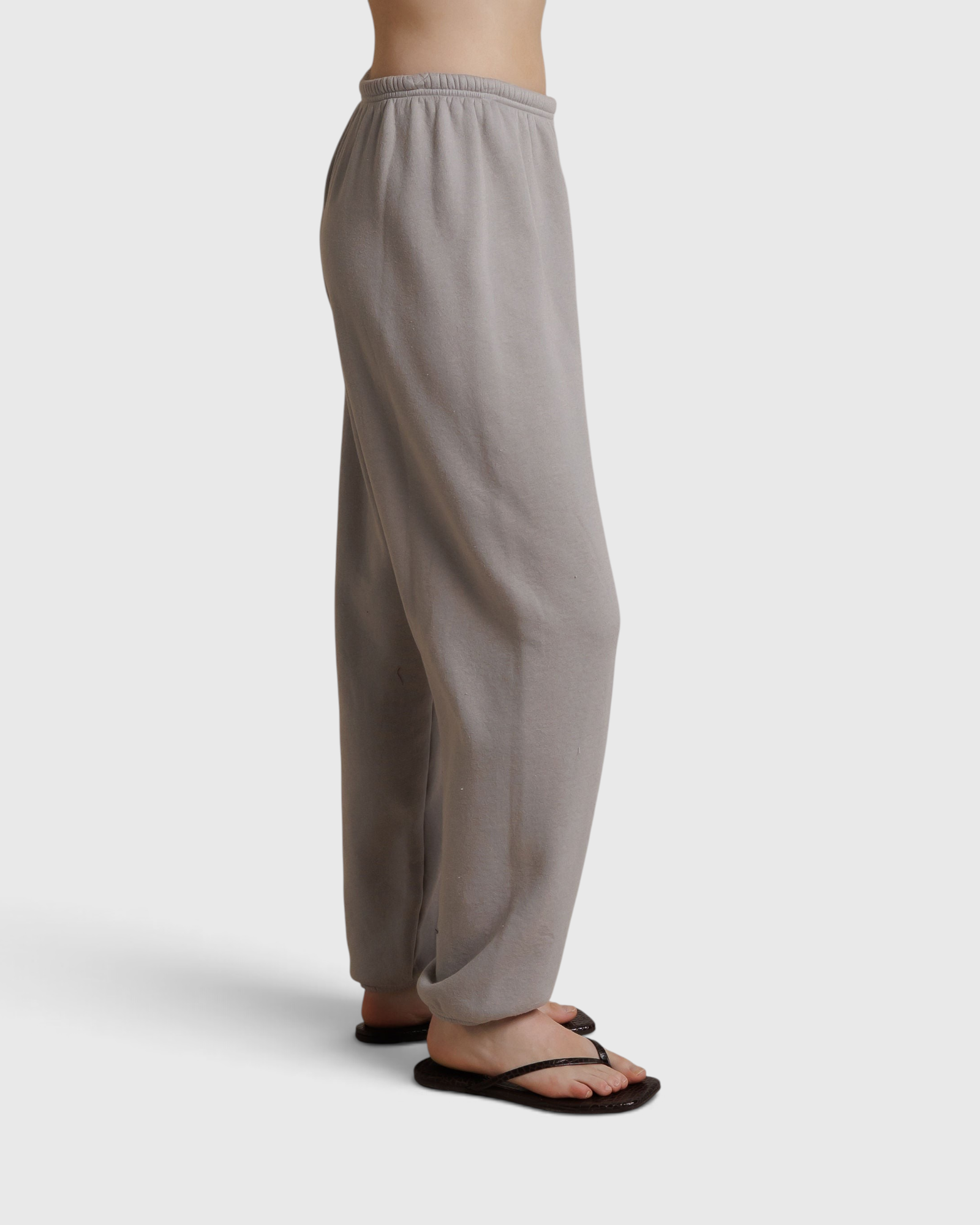 JONES + CO Dre sweatpants in cloud gray with an elastic waistband, shown from a side profile view.