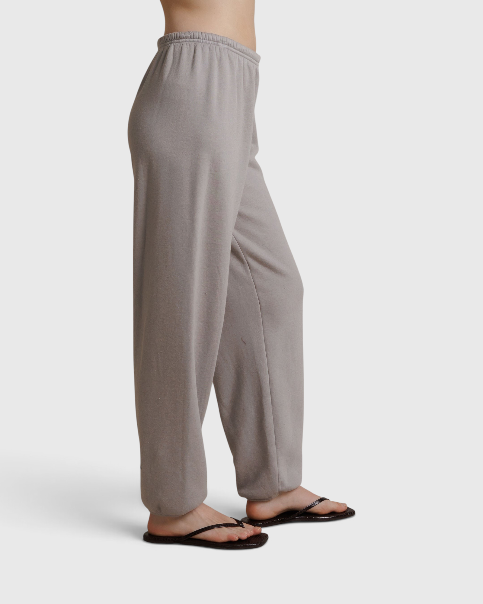 JONES + CO Dre sweatpants in cloud gray with a comfortable elastic waistband, shown from a side profile view.