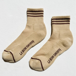 Pair of beige socks with brown stripes and 'Le Bon Shoppe' branding on a white background