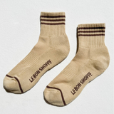 Pair of beige socks with brown stripes and 'Le Bon Shoppe' branding on a white background