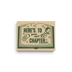 JONES + CO Next Chapter congratulations greeting card featuring a green book illustration on recycled kraft paper.