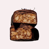 JONES + CO Almond Caramel Crunch chocolate bar with tamari almonds, dark Peruvian cacao, and blue cornflower garnish.