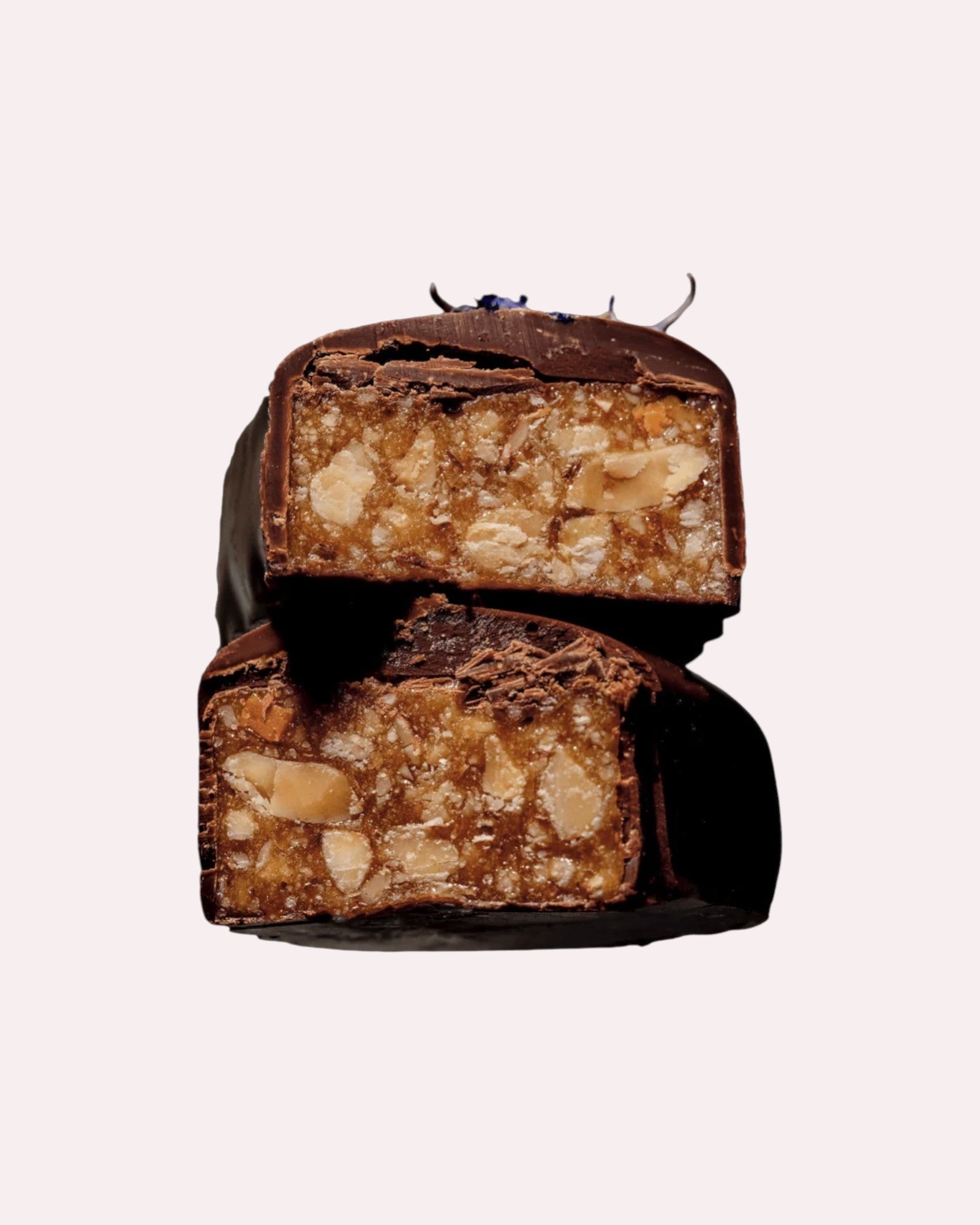 JONES + CO Almond Caramel Crunch chocolate bar with tamari almonds, dark Peruvian cacao, and blue cornflower garnish.