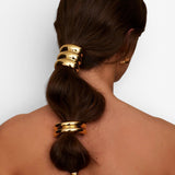 JONES + CO Anya Mini Pony Cuff in polished gold worn on a brunette ponytail to secure hair with a sleek finish.