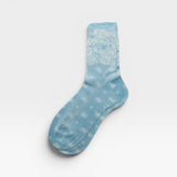 JONES + CO light blue Bahia socks with a white paisley bandana pattern and a subtle metallic finish.