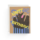 JONES + CO Bear Surprise birthday card featuring an illustrated bear popping out of a gift box on recycled paper.