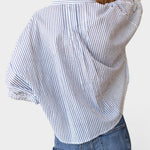 JONES + CO organic cotton blue indigo striped shirt with mandarin collar and batwing sleeves on a model.