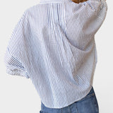 JONES + CO organic cotton blue indigo striped shirt with mandarin collar and batwing sleeves on a model.