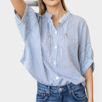 Model wearing JONES + CO organic cotton blue indigo striped button-front shirt with mandarin collar and batwing sleeves