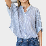 Model wearing JONES + CO organic cotton blue indigo striped button-front shirt with mandarin collar and batwing sleeves
