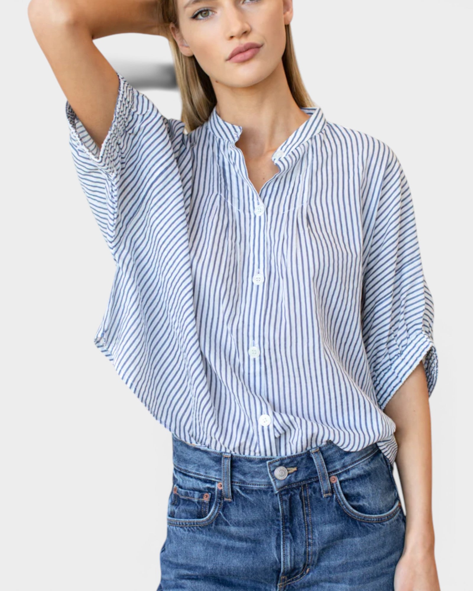 Model wearing JONES + CO organic cotton blue indigo striped button-front shirt with mandarin collar and batwing sleeves