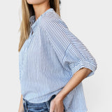 Model wearing JONES + CO blue indigo striped organic cotton top with mandarin collar and batwing sleeves.