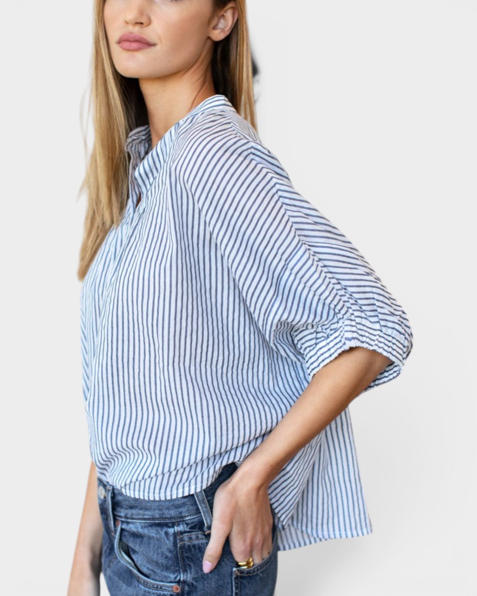 Model wearing JONES + CO blue indigo striped organic cotton top with mandarin collar and batwing sleeves.