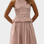 JONES + CO Cales Top in cinnamon white cotton check with a shirred bodice and peplum frill hem on a model.