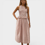 Model wearing JONES + CO Cales Top in cinnamon white check cotton with shirred bodice and peplum hem.