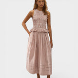 Model wearing JONES + CO Cales Top in cinnamon white check cotton with shirred bodice and peplum hem.