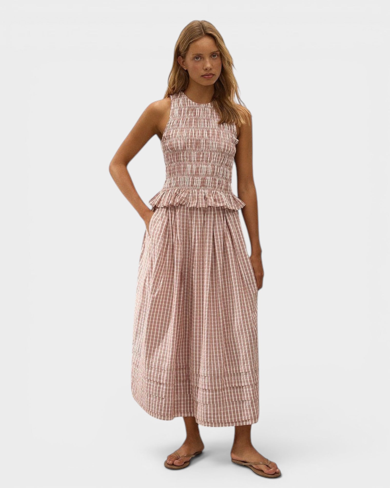 Model wearing JONES + CO Cales Top in cinnamon white check cotton with shirred bodice and peplum hem.