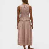 Model wearing JONES + CO Cales Top in cinnamon white cotton check with shirred bodice and peplum hem.