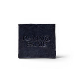 JONES + CO lavender and activated charcoal soap brick with a textured black finish and embossed logo.