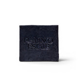 JONES + CO lavender and activated charcoal soap brick with a textured black finish and embossed logo.