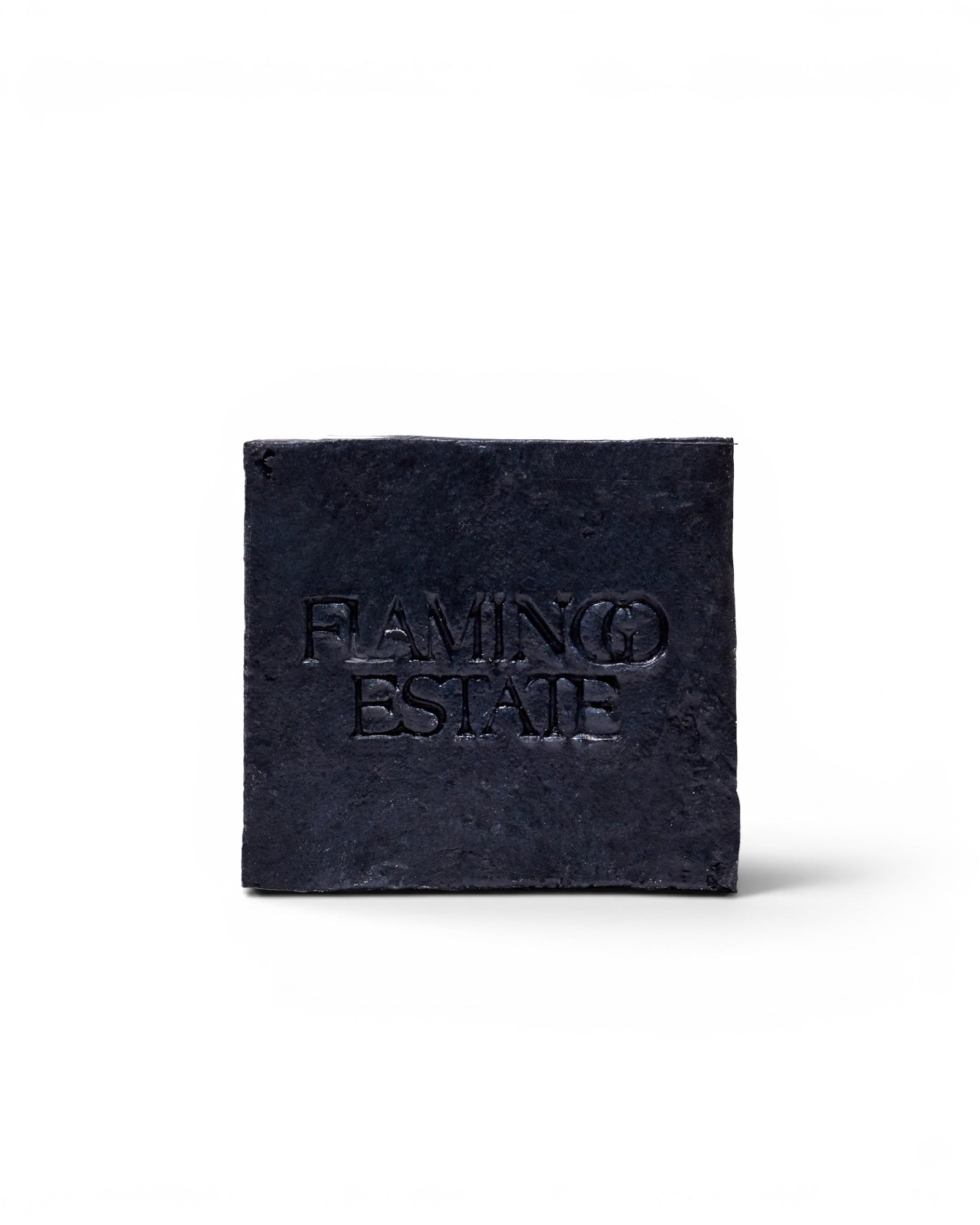 JONES + CO lavender and activated charcoal soap brick with a textured black finish and embossed logo.