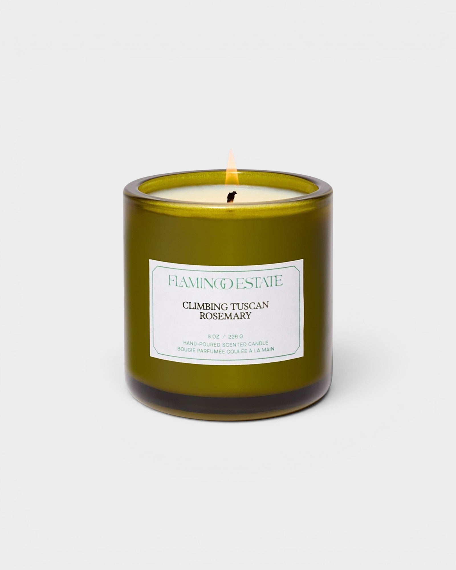 JONES + CO Climbing Tuscan Rosemary scented candle in a green glass jar with a white label.