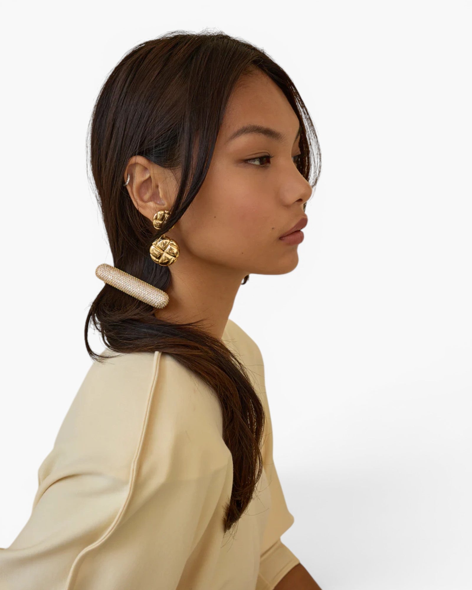 Model wearing a JONES + CO Crystal Pave Bar Barrette in a sleek, elongated design with sparkling crystals.