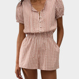 JONES + CO Emilie playsuit in cinnamon and white Paloma check with puff sleeves, button front, and elastic waist.