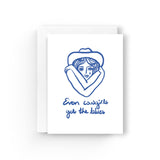 JONES + CO Even Cowgirls greeting card on recycled white paper with blue line art illustration and text.
