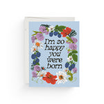 JONES + CO Full Circle greeting card with floral wreath illustration and I'm so happy you were born text on blue paper