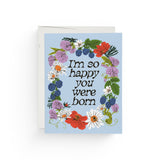 JONES + CO Full Circle greeting card with floral wreath illustration and I'm so happy you were born text on blue paper