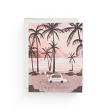 JONES + CO Getaway Car greeting card featuring a pink tropical beach illustration with a Just Married car.
