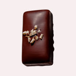 JONES + CO hazelnut butter praline chocolate bar topped with crunchy organic hazelnut pieces on a light background
