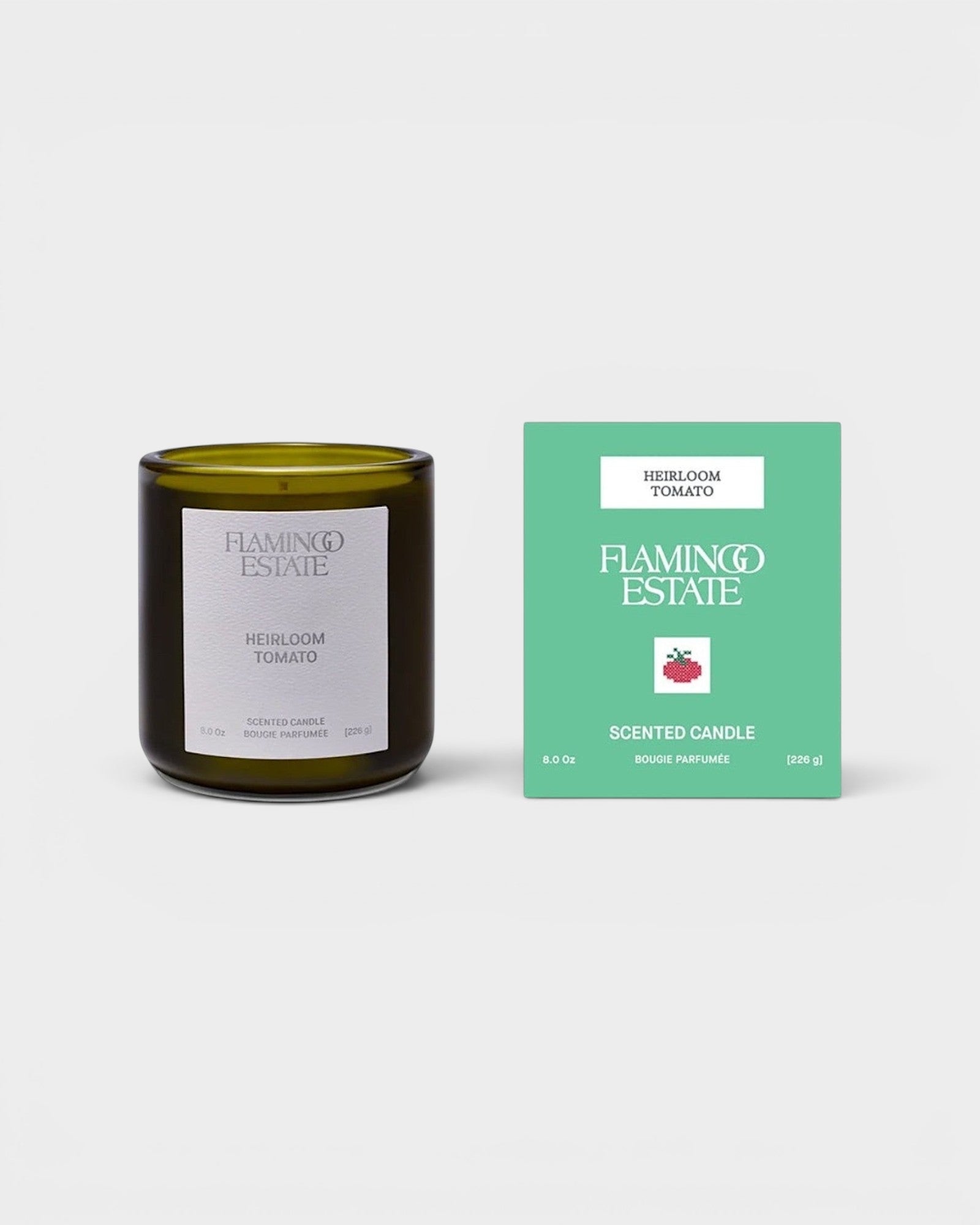 JONES + CO Flamingo Estate Heirloom Tomato scented candle in a dark green glass jar with its mint green box.