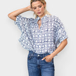 Model wearing JONES + CO organic cotton button-front top in indigo vine print with mandarin collar and batwing sleeves