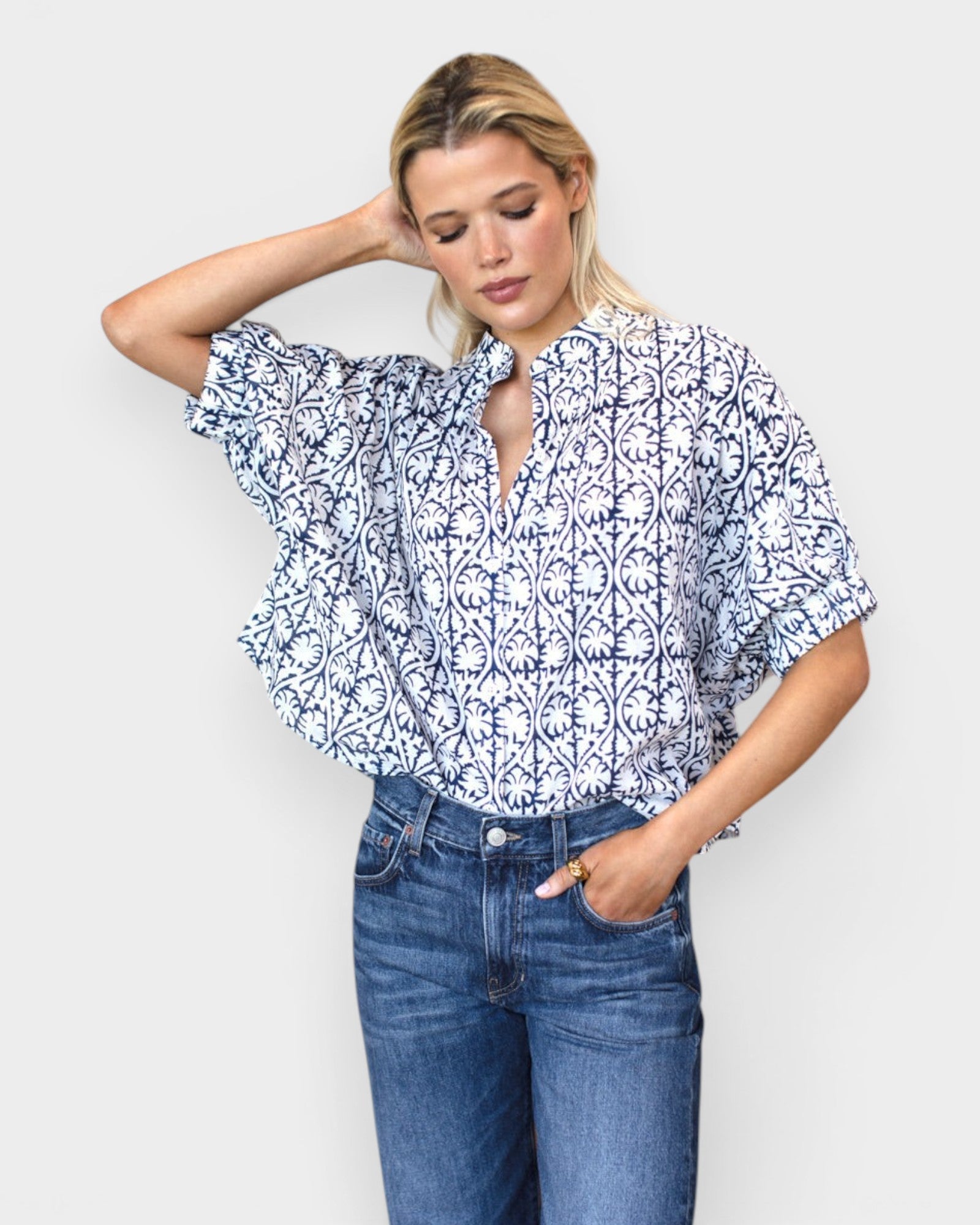 Model wearing JONES + CO organic cotton button-front top in indigo vine print with mandarin collar and batwing sleeves
