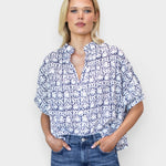 Model wearing JONES + CO organic cotton button-front shirt in indigo vine print with mandarin collar and batwing sleeves