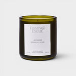 JONES + CO Night Blooming Jasmine and Damask Rose scented candle in a dark olive green glass vessel.