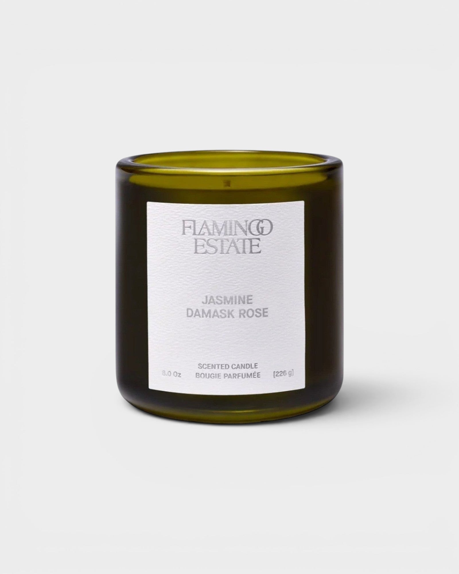 JONES + CO Night Blooming Jasmine and Damask Rose scented candle in a dark olive green glass vessel.